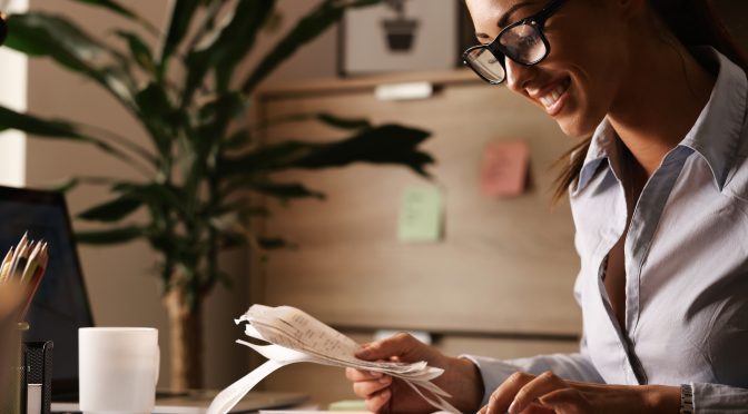 Business owner inspects her paperwork.