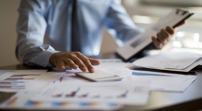 Businessman inspects his paperwork.