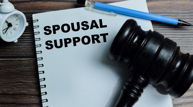 A notebook with the phrase "spousal support" written on it.